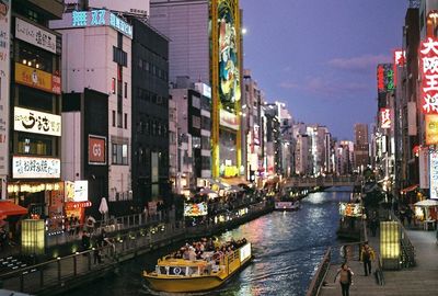 High angle view of people on boat in canal amidst city