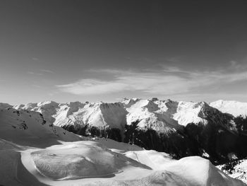 Scenic view of snow covered mountains against sky