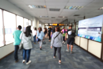 Rear view of people walking in corridor