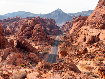 Scenic view of road amidst mountains against sky