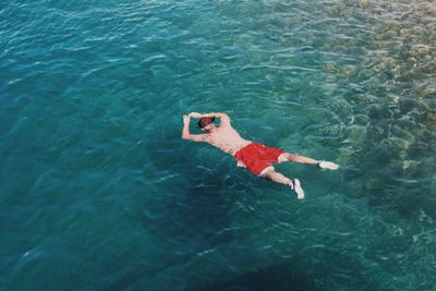 High angle view of man swimming in sea