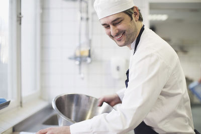 Happy baker working in commercial kitchen