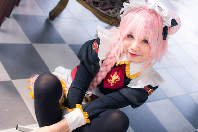 Portrait of a smiling young woman sitting outdoors