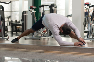 Muscular man exercising in gym