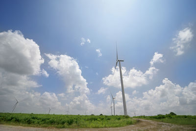 Windmill on field against sky