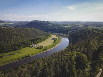 High angle view of road amidst trees against sky