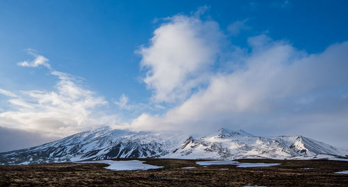 Scenic view of snowcapped mountains against sky