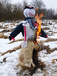 Man standing on snow covered field, farewell to winter