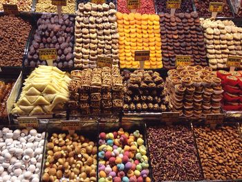 High angle view of various dried fruits for sale at market stall
