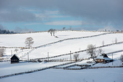 Snow covered field against sky