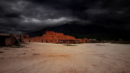 Built structures against cloudy sky