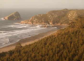 Scenic view of beach and mountains against sky