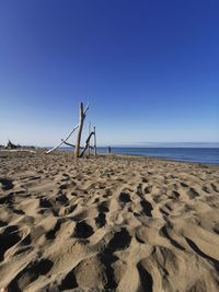 Scenic view of beach against clear blue sky