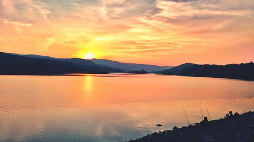 Scenic view of lake against sky during sunset