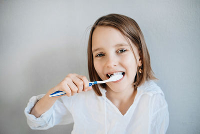 Girl brushes her teeth, dental care since childhood, a visit to the dentist