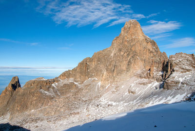 Scenic view of mountain against blue sky