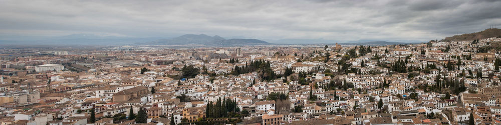 Cityscape against cloudy sky