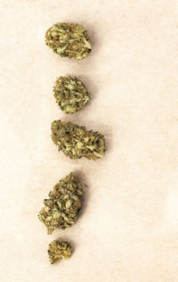 Detail of legal marijuana flowers photographed on paper background