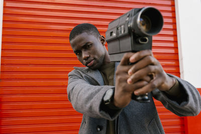 Portrait of young man photographing