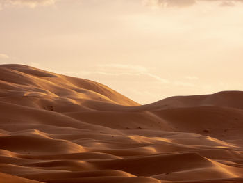 Scenic view of desert against sky during sunset