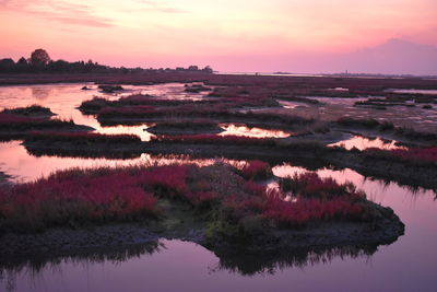 Scenic view of lake against sky during sunset