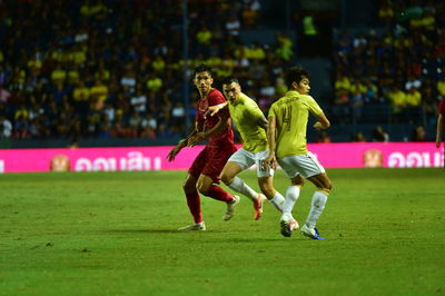 People running on soccer field