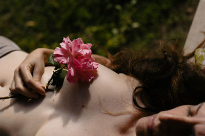 Midsection of woman with bouquet