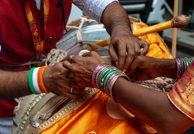 Low section of man holding hands