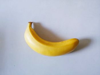 High angle view of yellow fruit on white background