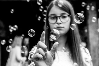 Portrait of woman holding bubbles