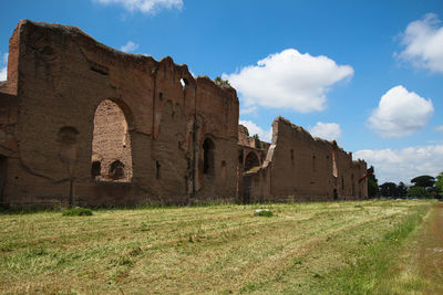 Old ruin building on field against sky