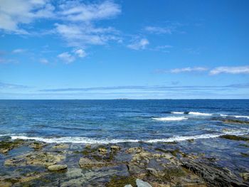 Scenic view of sea against cloudy sky