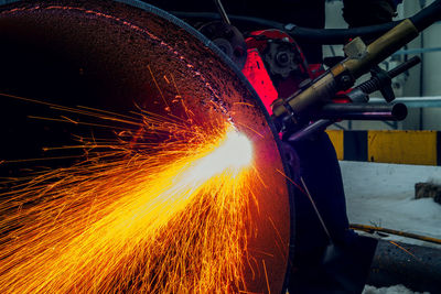 Low angle view of man welding metal