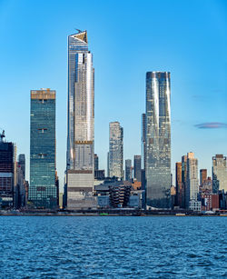 Modern buildings in city against blue sky