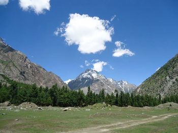 Scenic view of mountains against cloudy sky