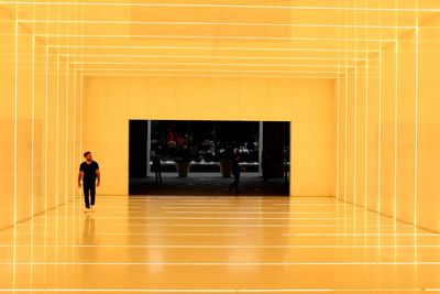 People walking in corridor of building