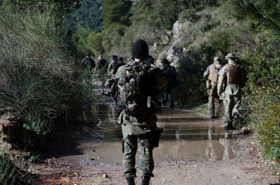 Special forces walk in forest