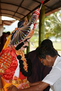 Midsection of man holding umbrella