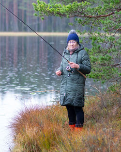 Rear view of man standing in lake