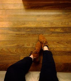 Low section of woman on hardwood floor