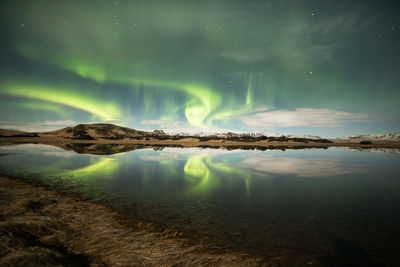 Scenic view of lake against sky at night