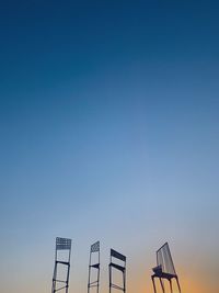 Low angle view of silhouette sign against clear sky