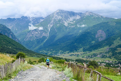 Rear view of man walking on mountain