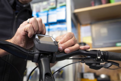 Close-up of man holding bicycle