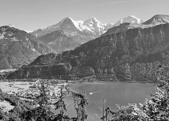 Scenic view with lake and snowcapped mountains against sky 