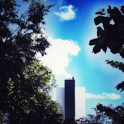 Low angle view of modern building against cloudy sky