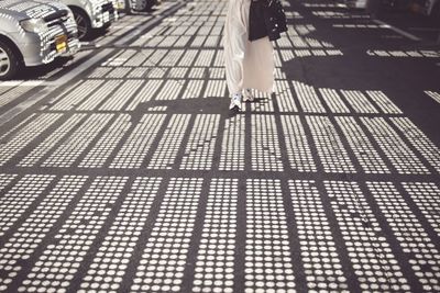 Low section of woman walking on street