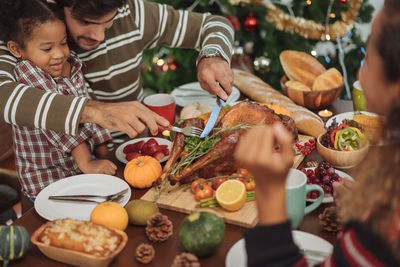 High angle view of people by food on table