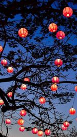 Low angle view of illuminated lanterns against sky