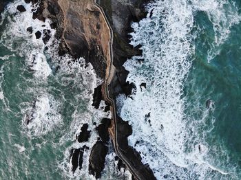 Aerial view of bridge at beach amidst sea